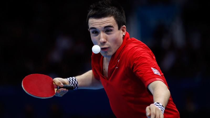 A picture of a man playing table tennis