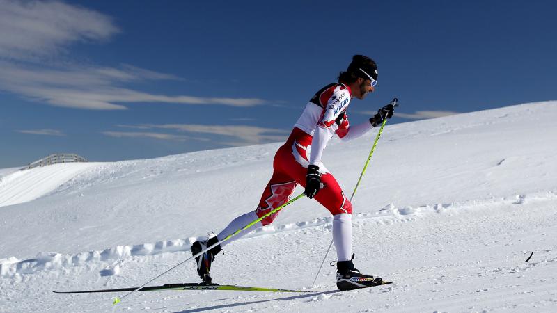 A picture of a man skiing a biathlon