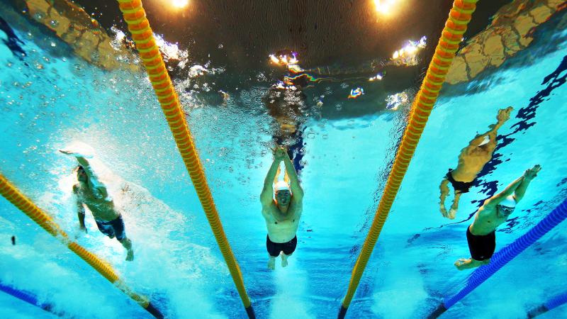 A picture of three men underwater