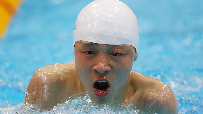 A picture of a man in the pool holding his head above the water