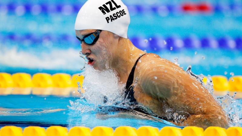 A picture of a woman in the pool with her head and shoulders above the surface