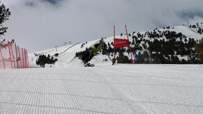 A picture of a woman in a sledge practising snowboard