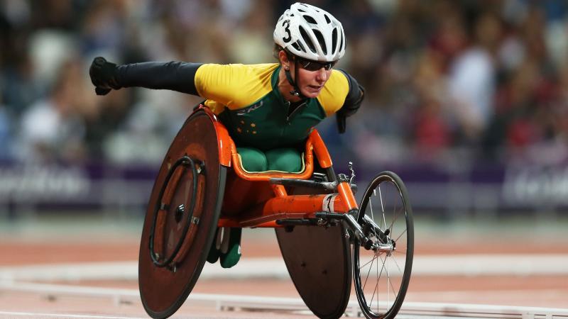 A picture of a woman in a wheelchair during a wheelchair race