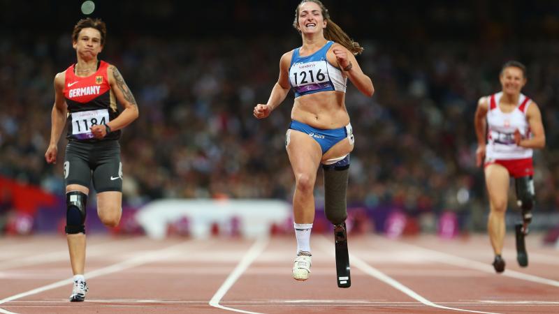 A picture of women running on a tracking field