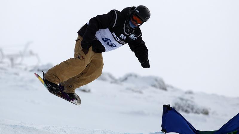 A picture of a man practising snowboard