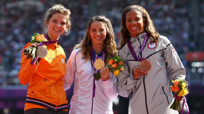 A picture of women on a podium with medals around their neck