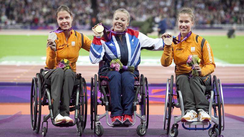 A picture of women on a podium with medals around their neck