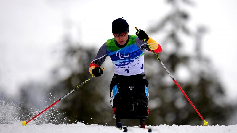 A woman in the wheelchair at the biathlon track