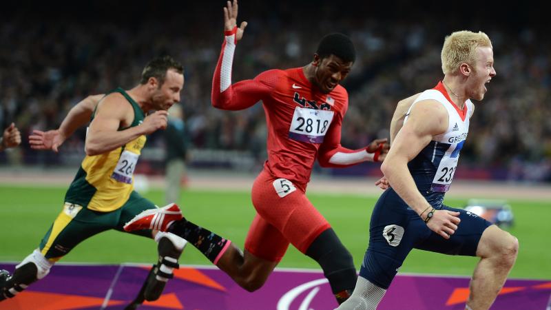 A picture of men running through a finishing line