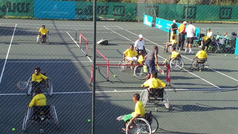 A picture of person in wheelchairs playing tennis