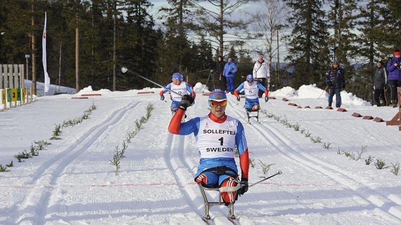 A picture of a man celebrating after crosses the finish line