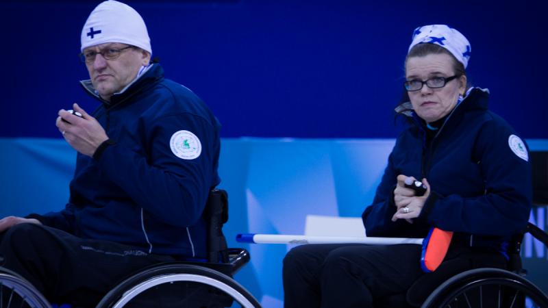 A picture of a man and a woman in wheelchairs