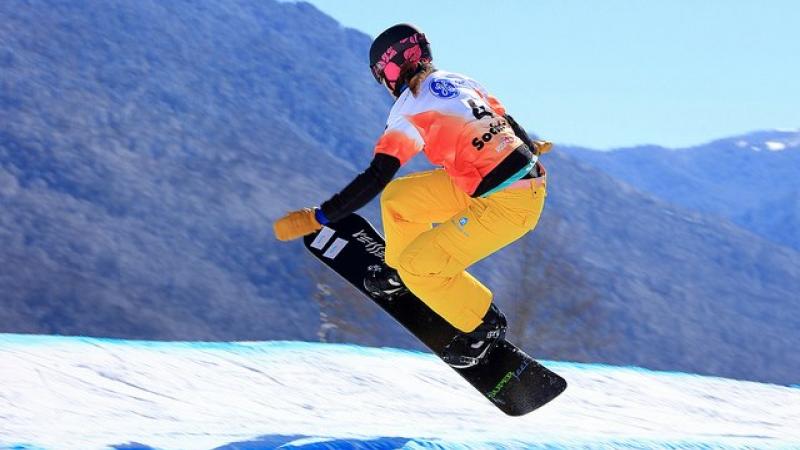 A picture of a woman doing snowboarding.