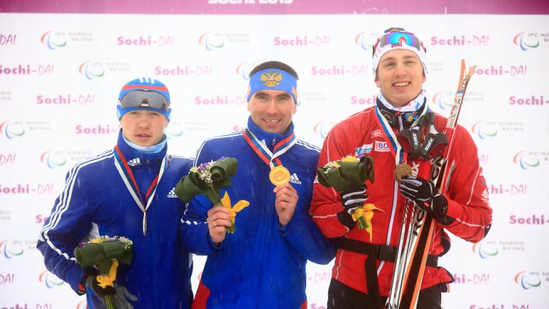 standing men on podium for cross country sprint