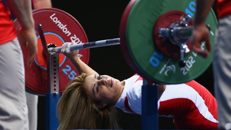 A picture of a powerlifter on a bench competing