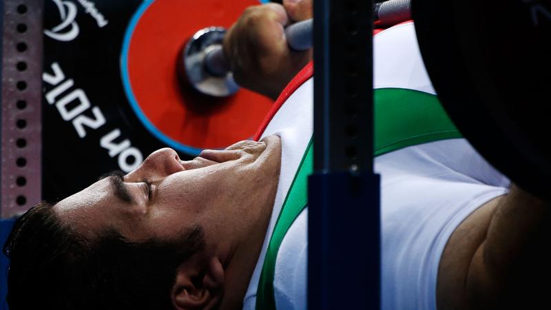 A picture of a powerlifter on a bench competing