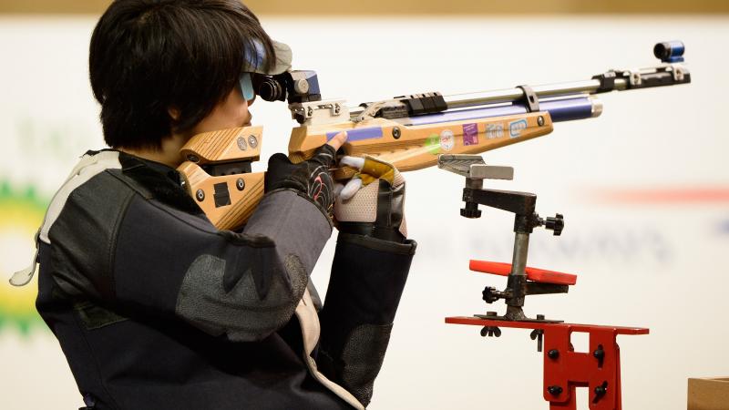 A picture of a woman competing in shooting