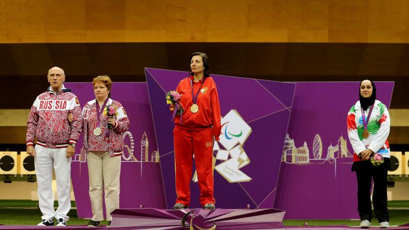 A picture of women on a podium with medals around their neck