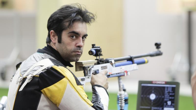 A picture of a man posing during the shooting competition