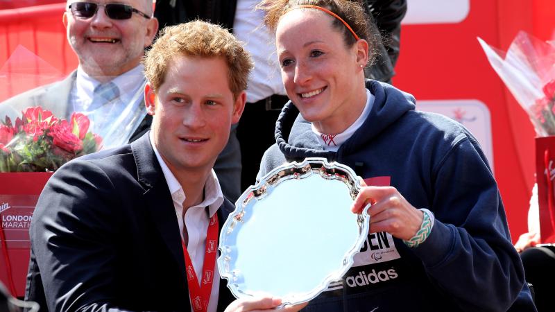 Prince Harry presents Tatyana McFadden with her 2013 London Marathon trophy