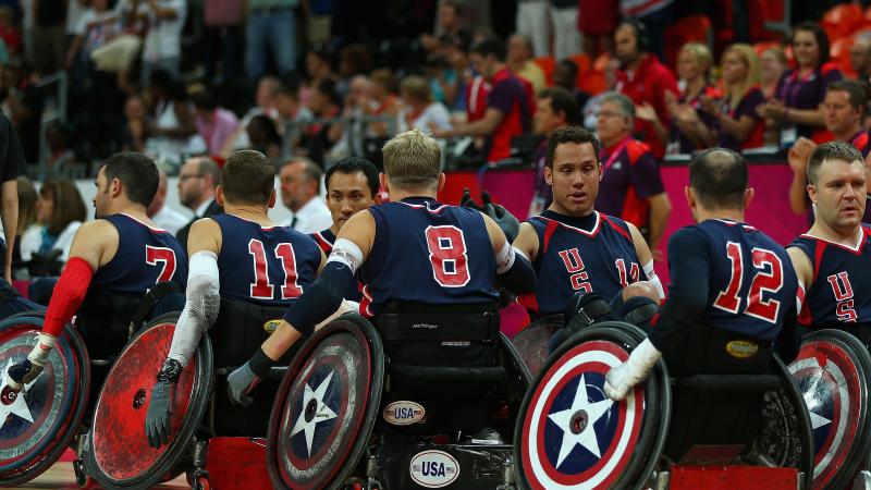 Players in wheelchairs lining up and high five