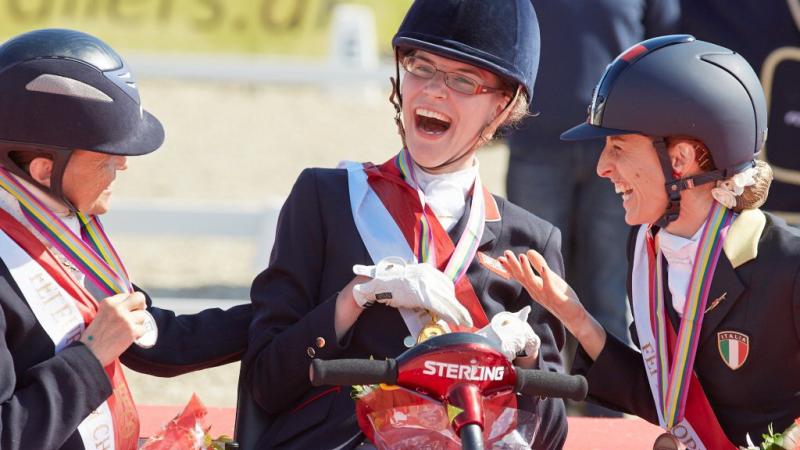 Grade 1a Freestyle gold medallist Sophie Christiansen (GBR), celebrating with compatriot Anne Dunham who took silver and bronze medallist Sara Morganti (ITA), at the JYSK FEI European Para-Dressage Championships in Herning (DEN).