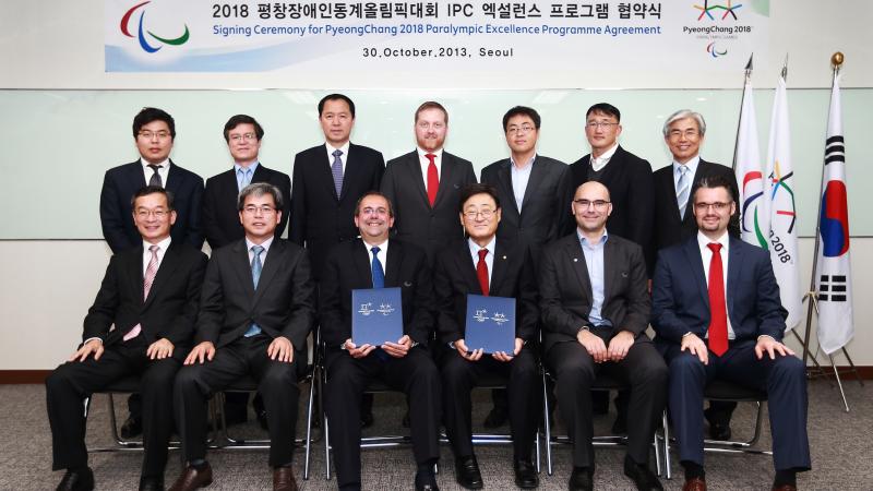 Members of the IPC and PyeongChang2018 Organising Committee celebrate the signing of the 2018 Excellence Programme