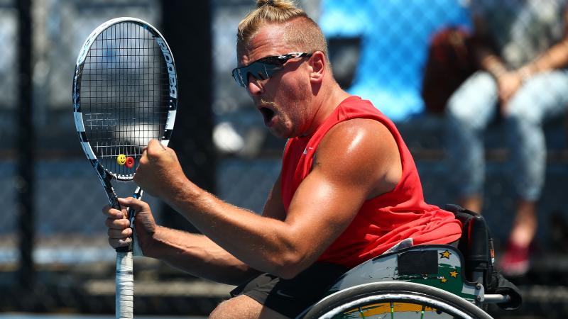 Dylan Alcott celebrates winning his quad wheelchair tennis singles match against Great Britain's Andy Lapthorne at the 2014 Australian Open. 
