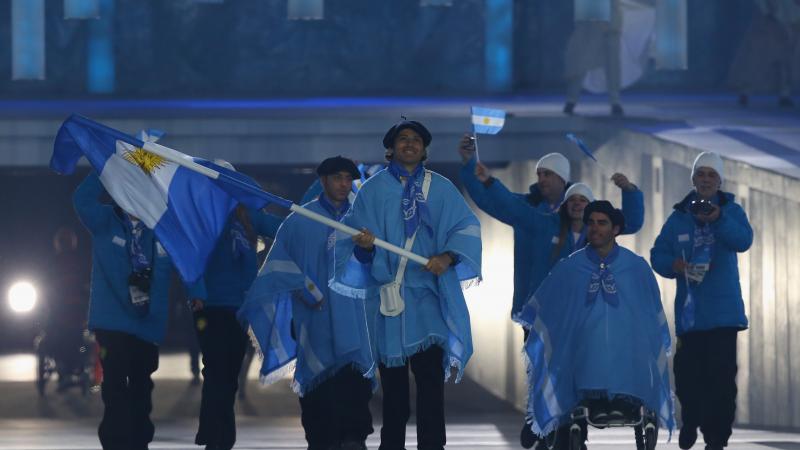 Argentina enter the arena lead by flag bearer Pablo Javier Robledo during the Opening Ceremony of the Sochi 2014 Paralympic Winter Games