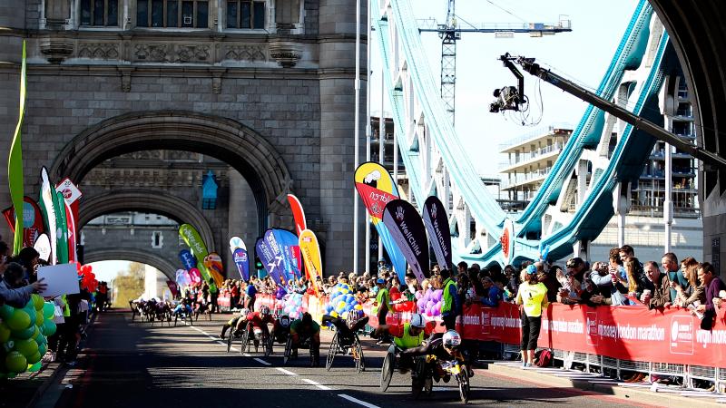Men's wheelchair racers cross Tower Bridge in the 2014 Virgin Money London Marathon