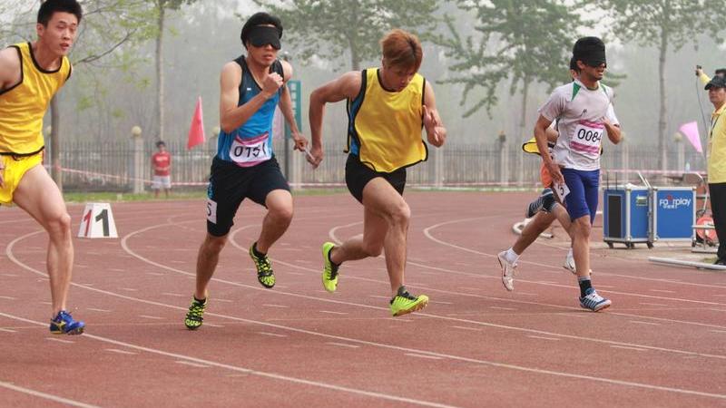 Athletes with a visual impairment compete in the 100m at the 2014 IPC Athletics Grand Prix in Beijing.