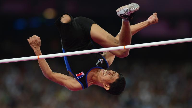 Andy Avellana of the Philippines jumps over the bar in the men's high jump.