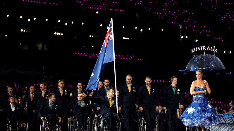 An athlete carries Australia's flag through the stadium at the London 2012 Opening Ceremony.