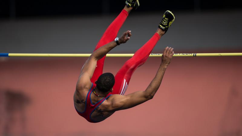 The back of Luis Felipe Gutierrez Rivero is seen as he jumps over the high bar.