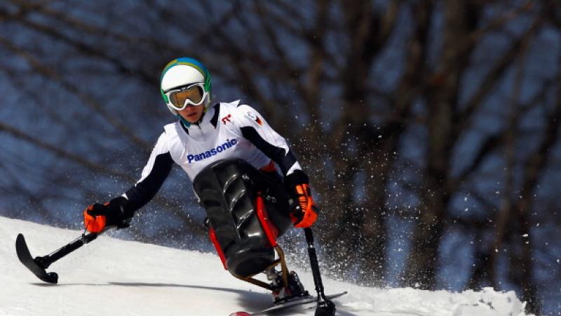 Athlete practicing alpine skiing in a sit-ski.