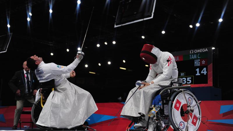 Athletes practicing wheelchair fencing.