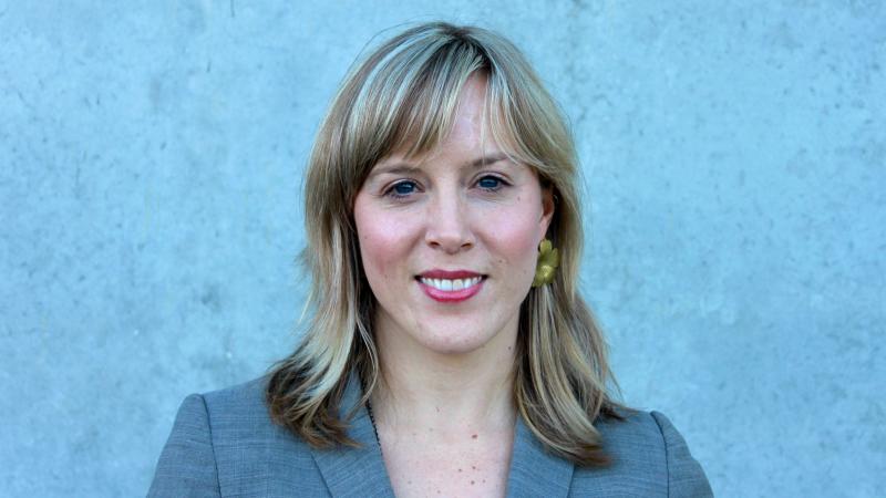 A woman is staring at the camera in a horizontal portrait shot. 