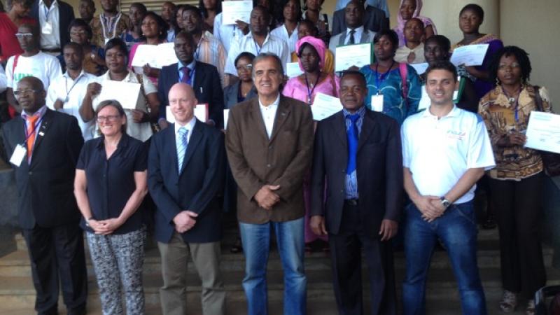 A group of about 40 people pose for a photo after a workshop.