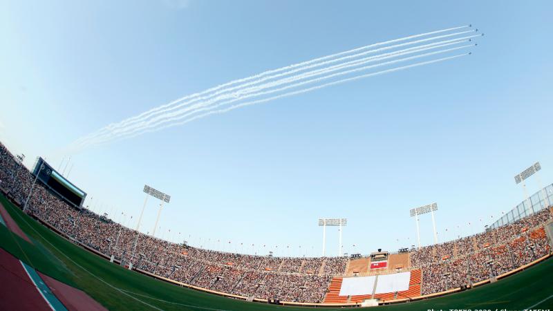 Japan Air Self-Defense Force aerobatic demonstration team ‘Blue Impulse’ in action over the National Stadium and 40,000 fans.