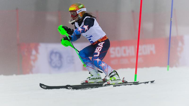 Women passing a slalom pole on the slopes