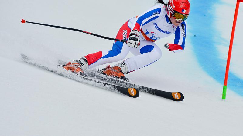 France's standing skier Marie Bochet skiing around a gate.