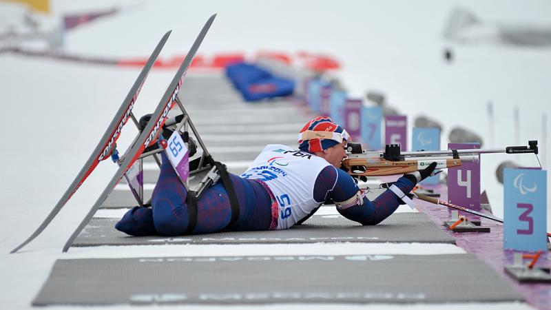Trygve Steinar Larsen, Norway lines up his shot in biathlon.