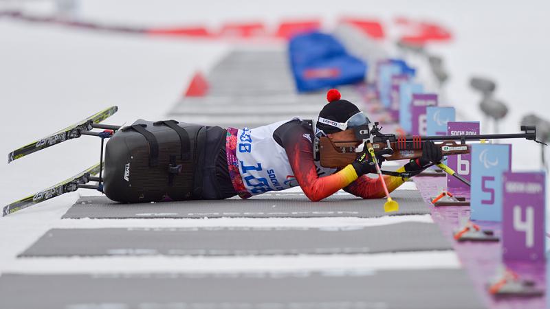 Women in sit ski lies in the shooting range and targets