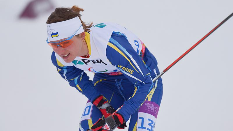 Female skier looks exhausted on the snow.