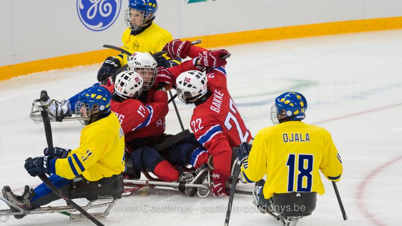 five athletes in sledges on the ice
