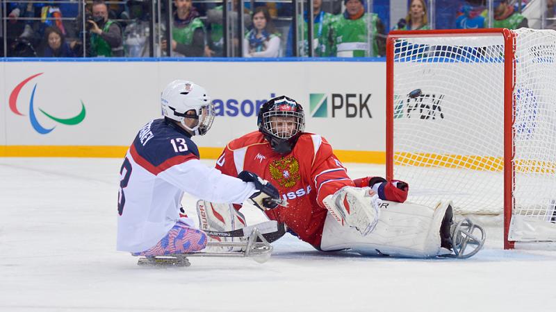 The USA's Josh Sweeney crashes the net during the Sochi 2014 Paralympic Winter Games.