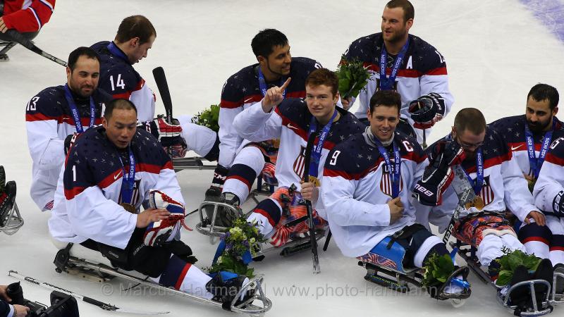 US players in their sledges on the ice after winning against Russia.