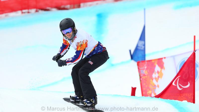 Amy Purdy going over a hill in the snowboard cross course in Rosa Khutor.