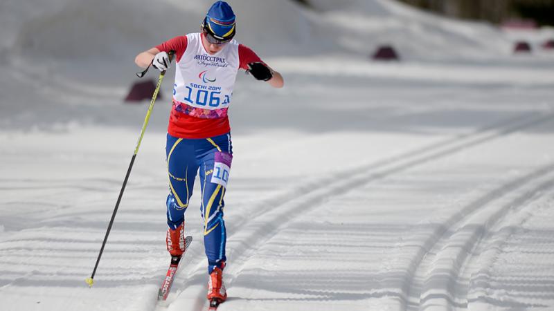 Cross country skier in race suit in a slope