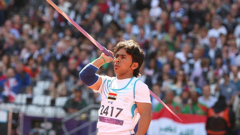 Man holds javelin and prepares to throw